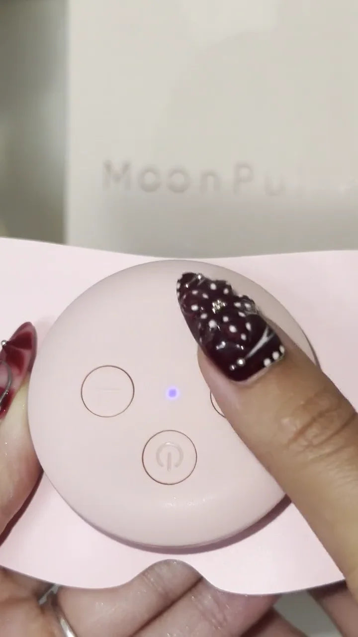 A hand at the two side controls of the real MoonPulse device.