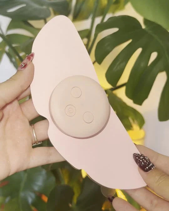 Real MoonPulse device and butterfly-shaped pad held in hands. No product model or generated structure.