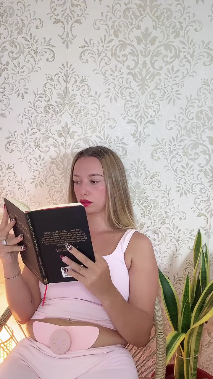 MoonPulse worn on the lower abdomen while sitting and reading at home.